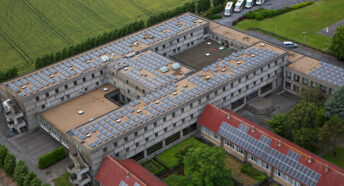 Photovoltaic solar panels on roof providing electricity by sun energy to office buildings