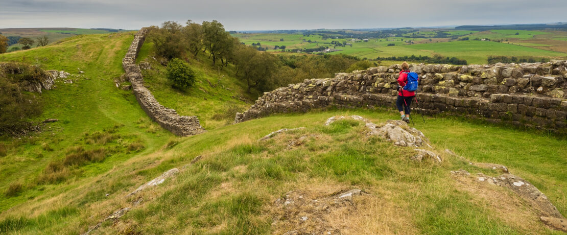 A person walking along Hadrian's Wall