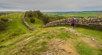 A person walking along Hadrian's Wall