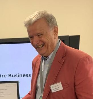 Martin Gillie holding volunteer award certificate