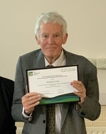 Photo of Richard Lloyd holding his award