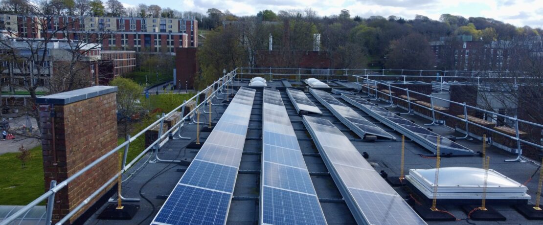Solar panels along roof of campus building