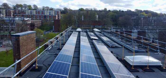 Solar panels along roof of campus building