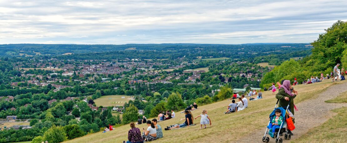 Box Hill in Dorking on a summers day with lots of walkers and people enjoying the view