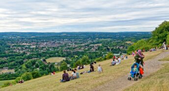 Box Hill in Dorking on a summers day with lots of walkers and people enjoying the view