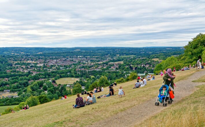 Box Hill in Dorking on a summers day with lots of walkers and people enjoying the view