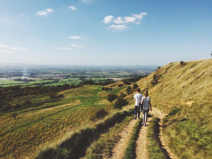 Two people walking along the Cotswold Way in Gloucestershire