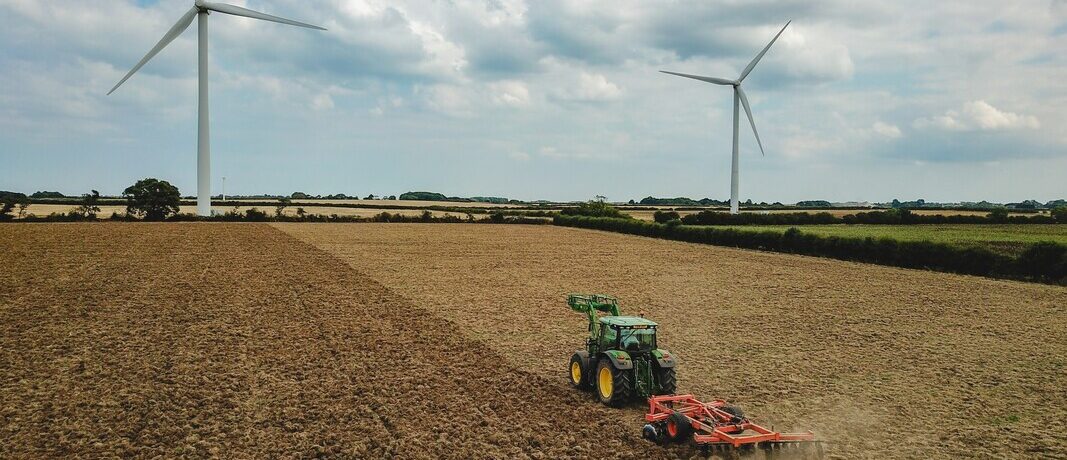 Tractor with wind turbine in background
