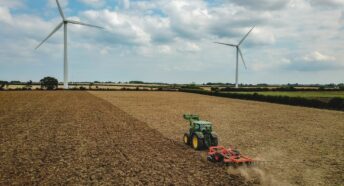 Tractor with wind turbine in background