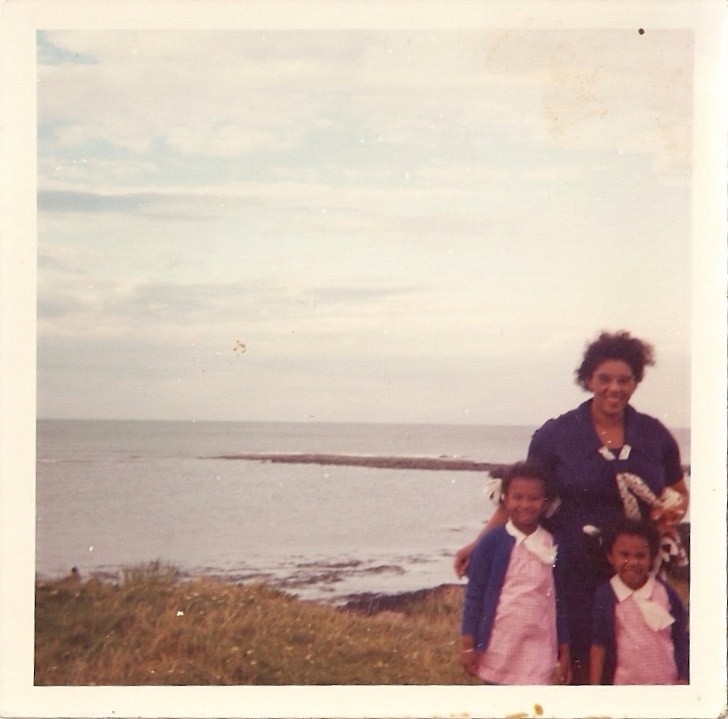Three women stood by the sea - old photograph 