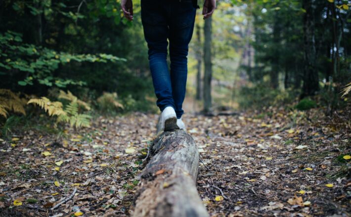 Walking on a log in the woods