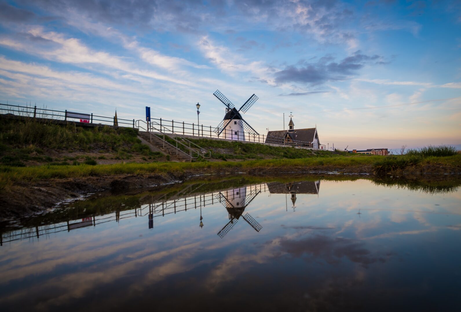 A view of the waterside at Lytham St Annes, with a windmill in the background