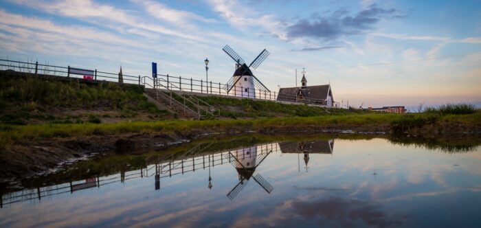 A view of the waterside at Lytham St Annes, with a windmill in the background