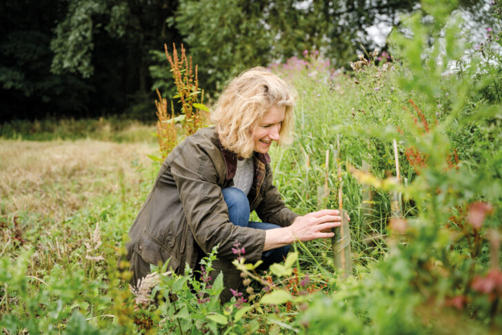 Ruth Grice inspecting some plants on her farm