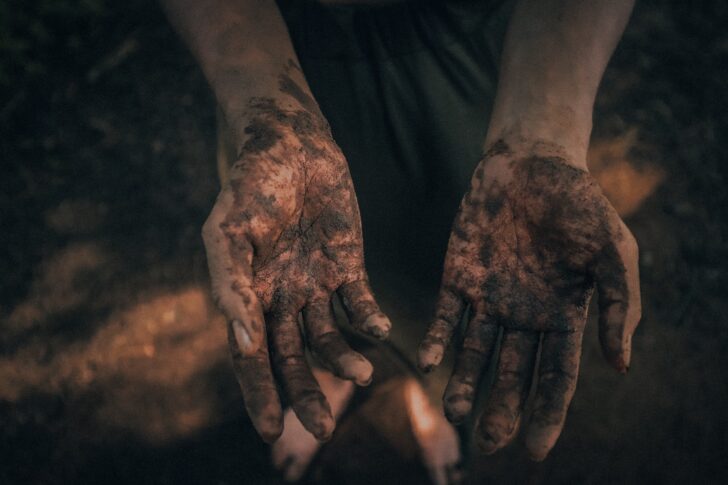 Hands covered in soil