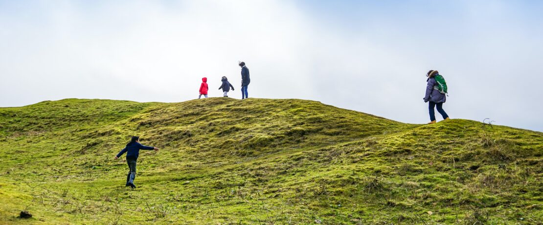 Adults and children hiking in the Cotswolds