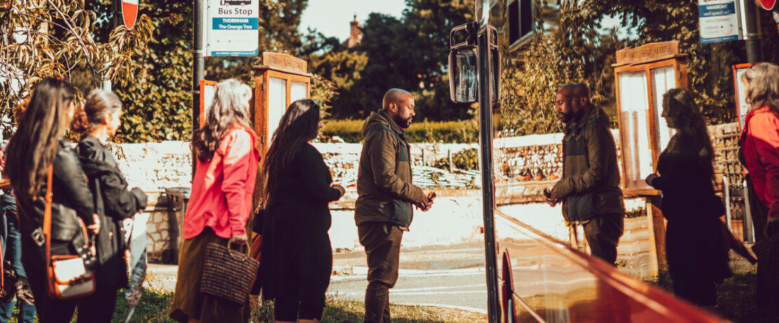 Group of people in a queue to get on a bus