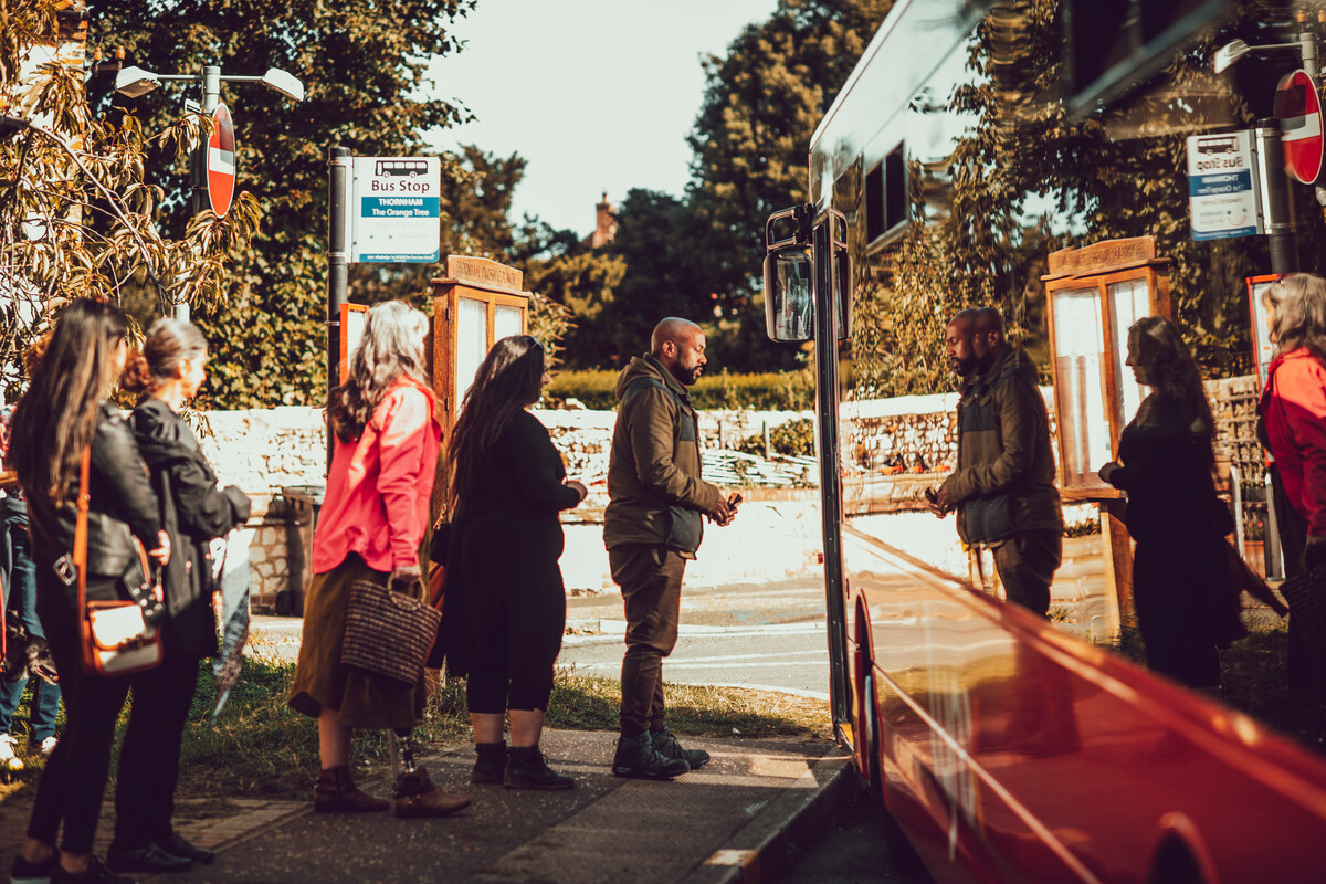 Group of people in a queue to get on a bus