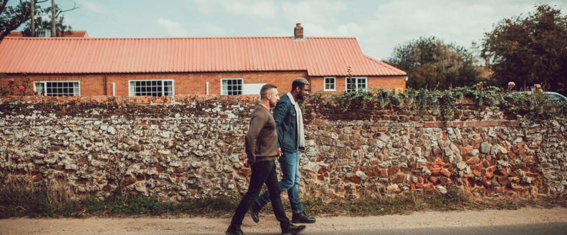 A couple on a walk through a rural village