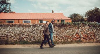A couple on a walk through a rural village