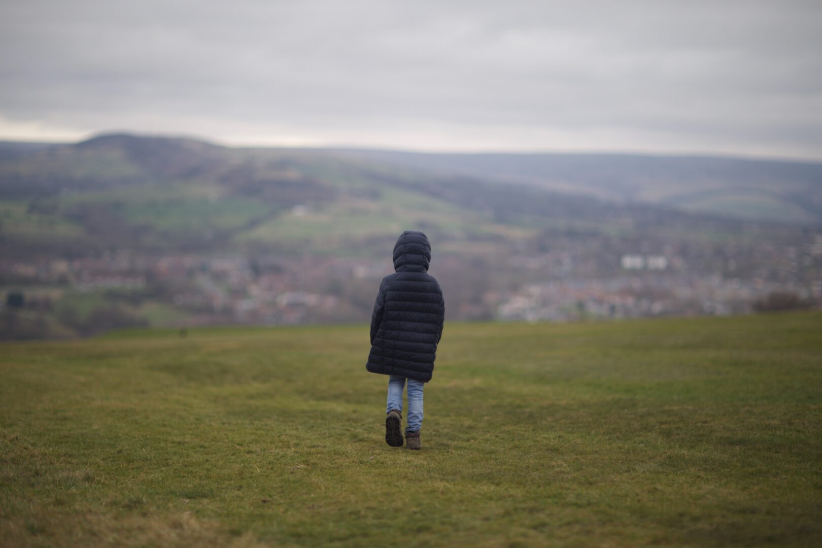 A child walking on a field in Hyde, near Manchester