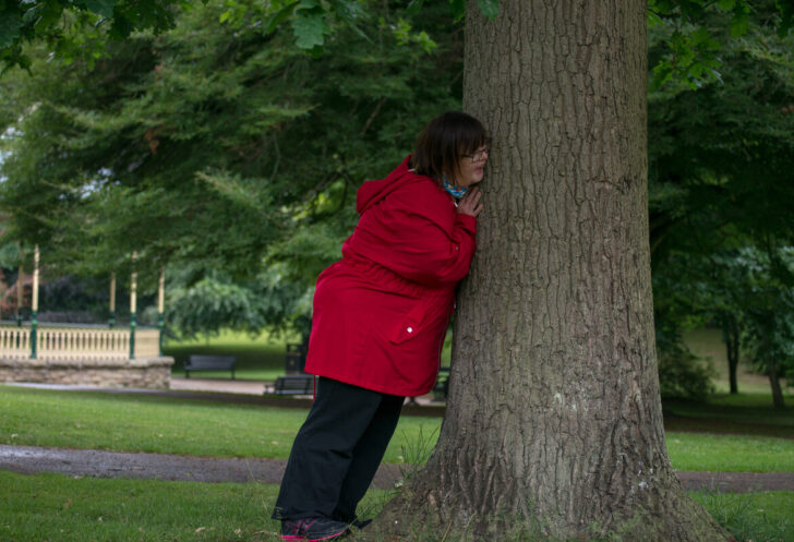 Leaning against a tree