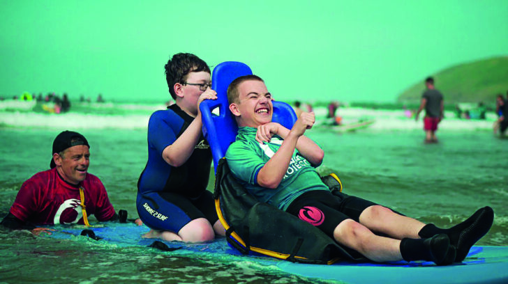 A boy on a seated surfboard