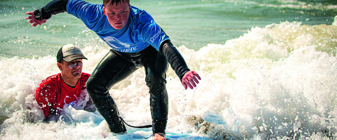 A surfer in action at The Wave Project’s adaptive surfing hub