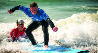A surfer in action at The Wave Project’s adaptive surfing hub