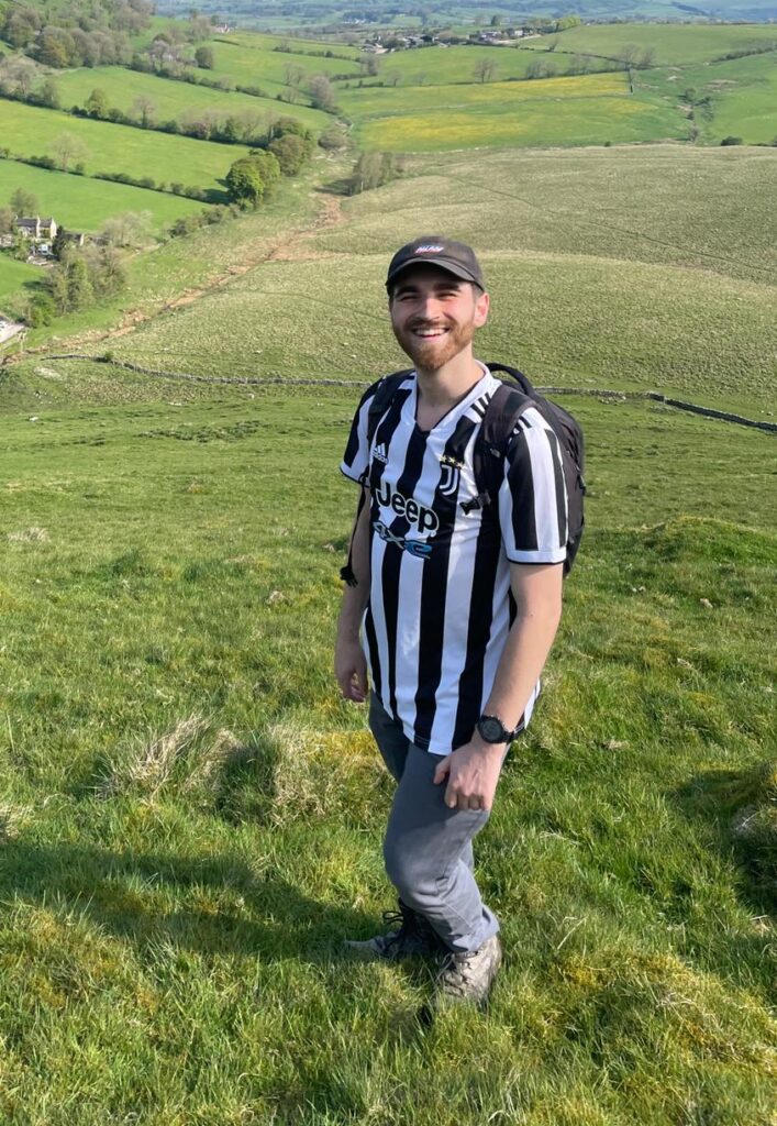 Craig Ireton stood in countryside wearing football shirt
