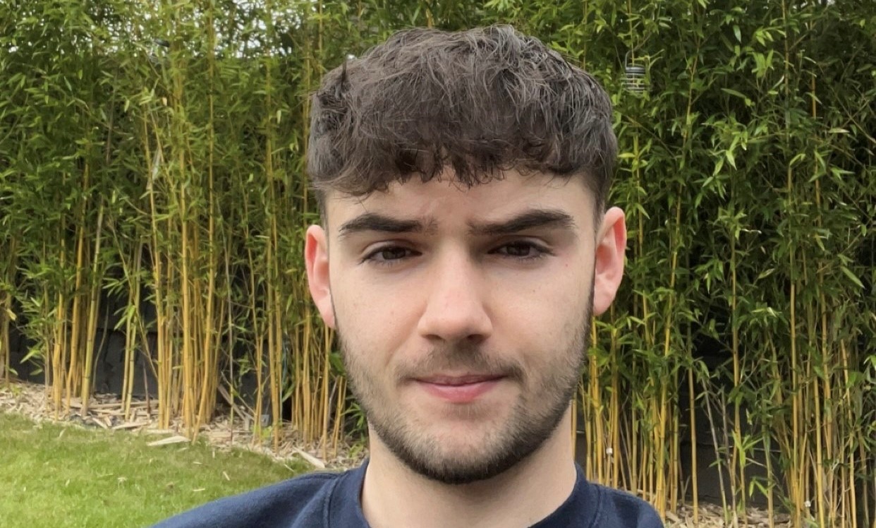 Photo of Jacob stood in front of some bamboo