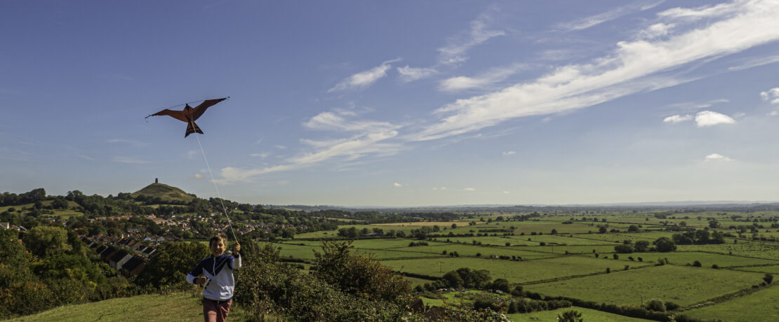 Boy flying kite in the countryside