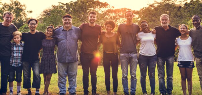 Group of people with arms around each other in unity
