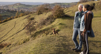 Two women looking out at a view on a rolling hill walk- greenbelt