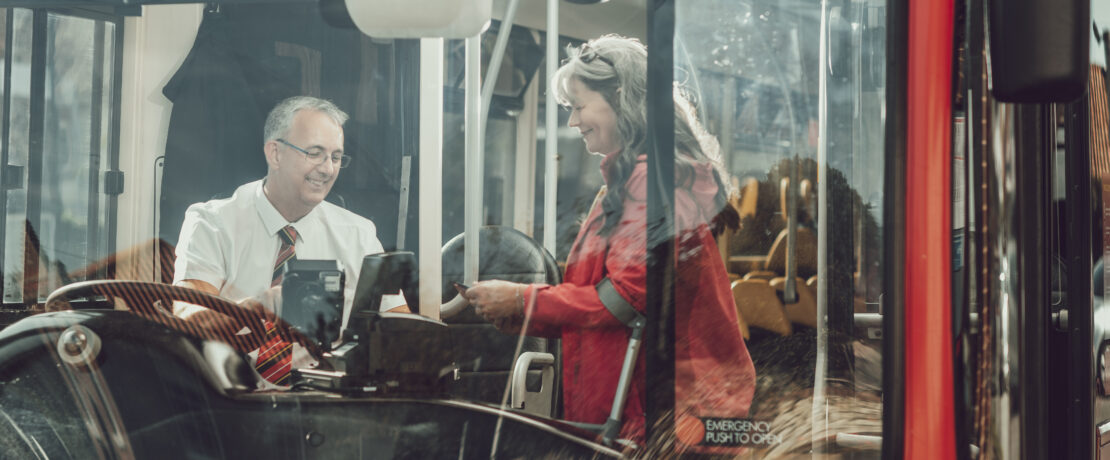 Woman paying to get on a bus