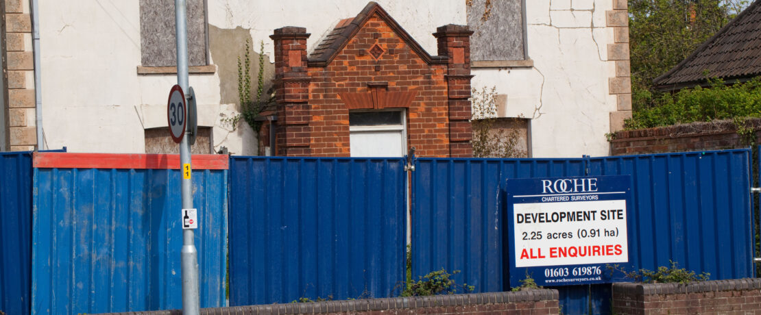 Sign sale of development at a derelict property