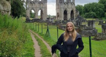 Photo of Poppy outside a ruin in the countryside