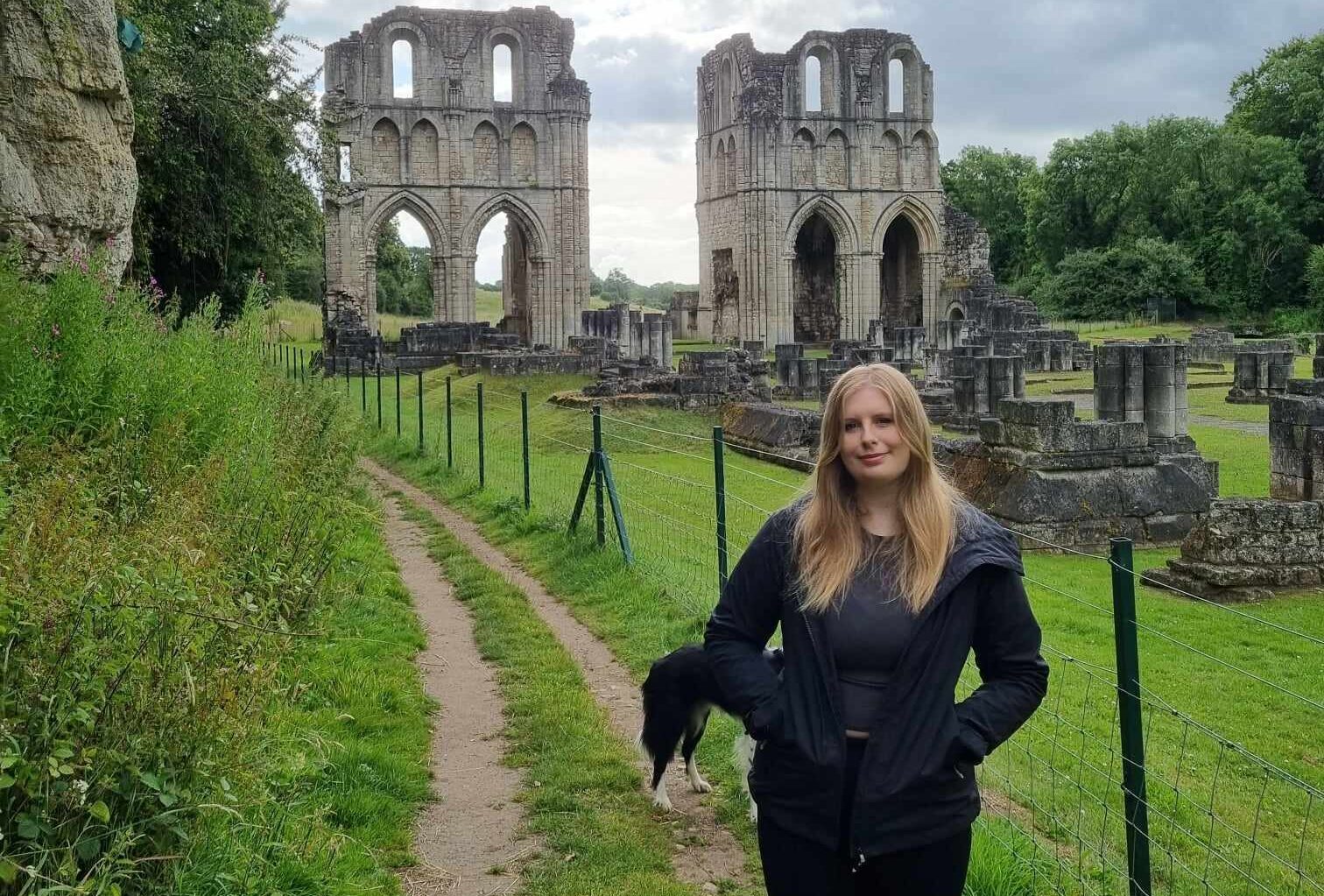 Photo of Poppy outside a ruin in the countryside