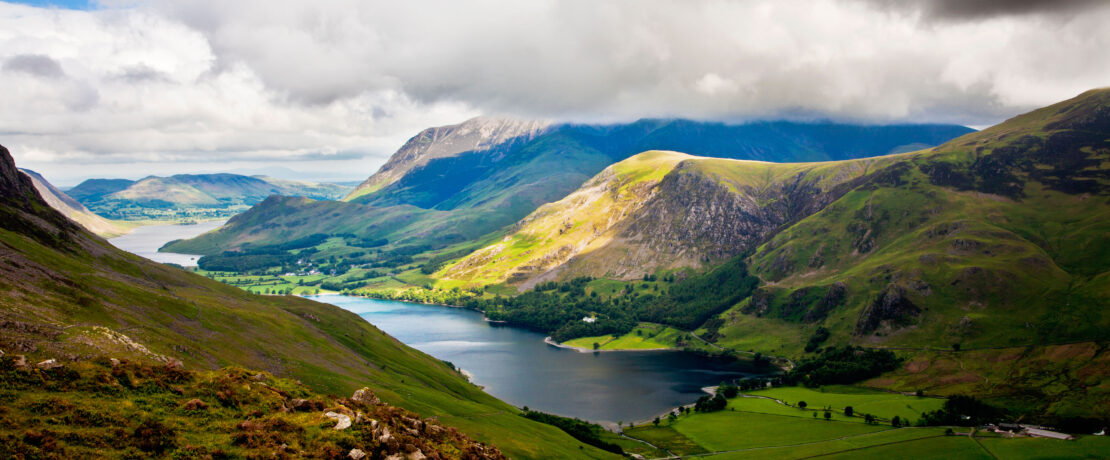 A view across the peaks and river at the Lake District National Park