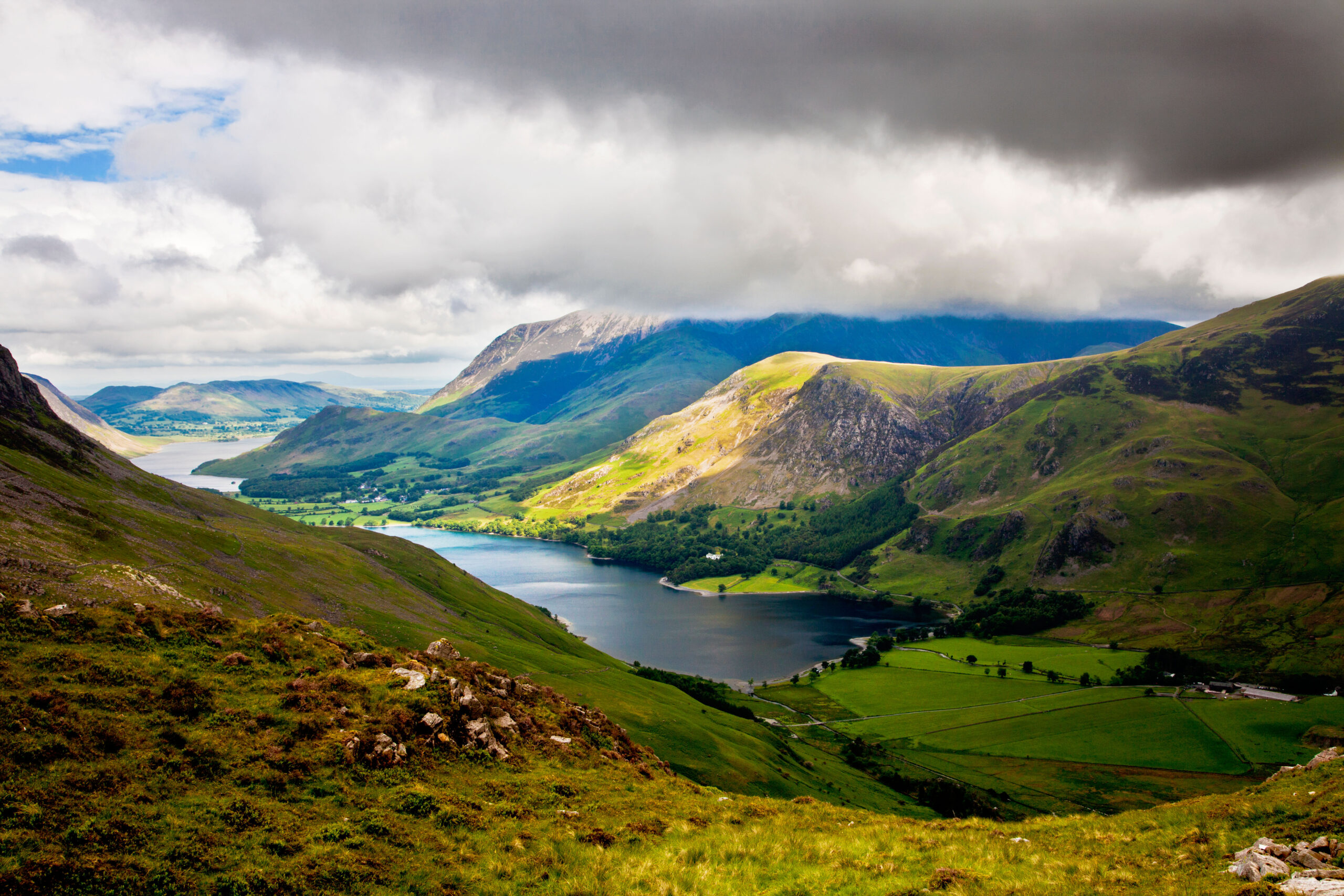 A view across the peaks and river at the Lake District National Park