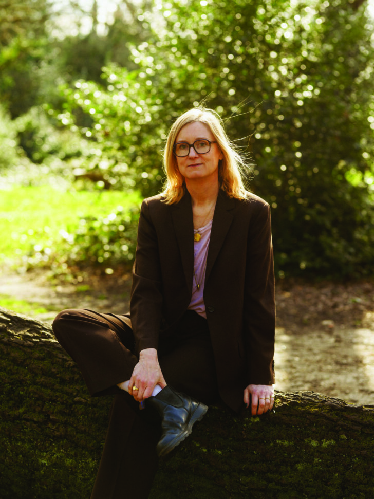 Photograph of Kate Worseley sitting on a stonewall