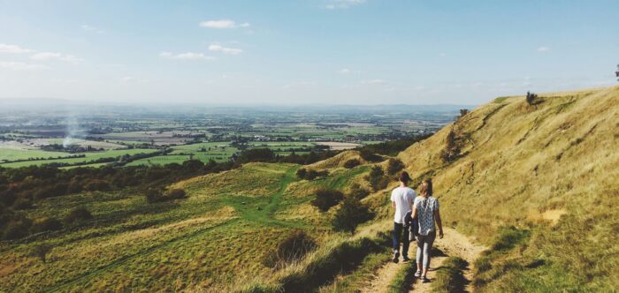 Two people walking on a countryside trail