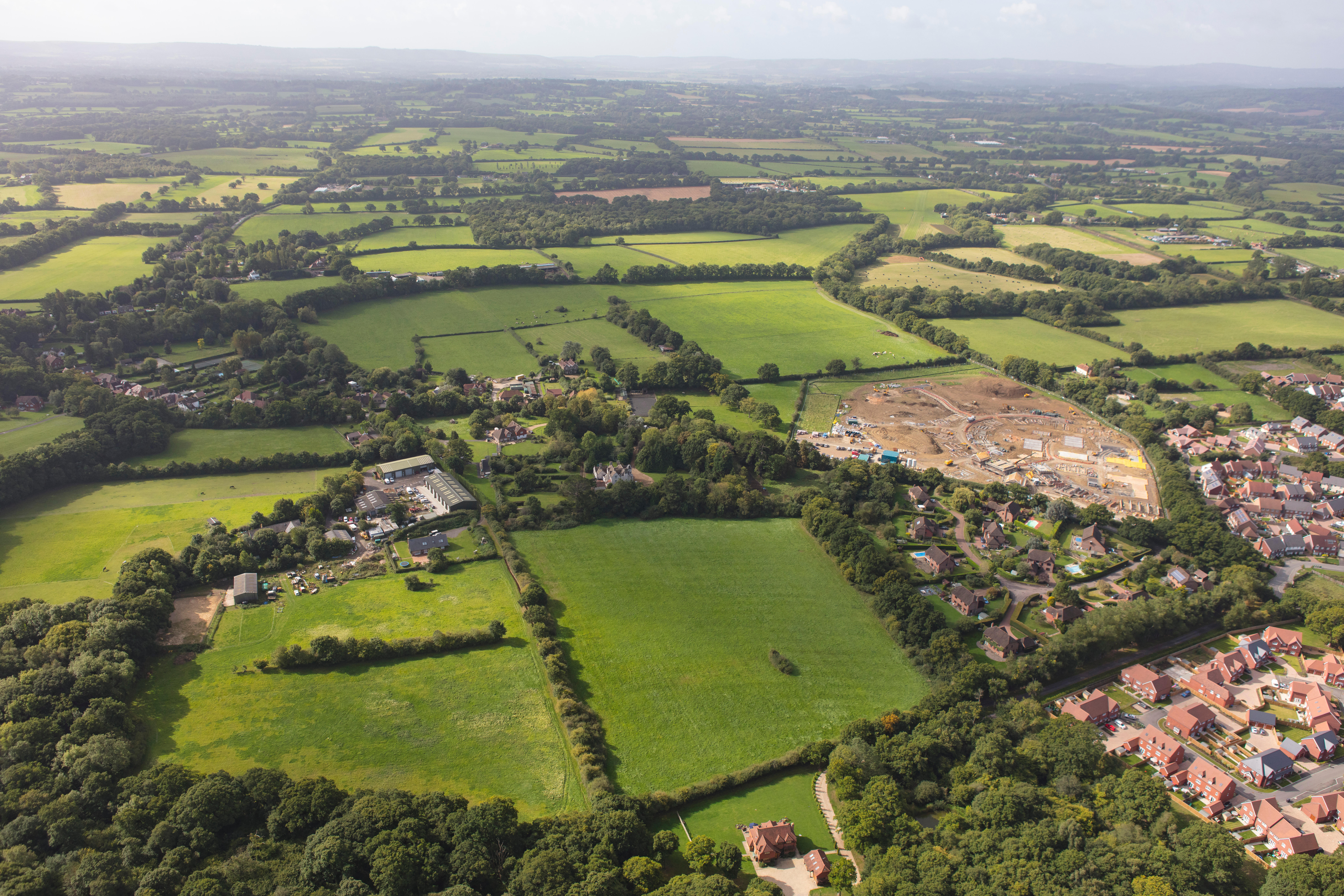 An aerial view illustrating housing development around the edge of a Sussex town