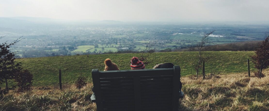 Two children sitting on bench looking at the landscape views