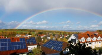 Rooftop solar on homes with rainbow above