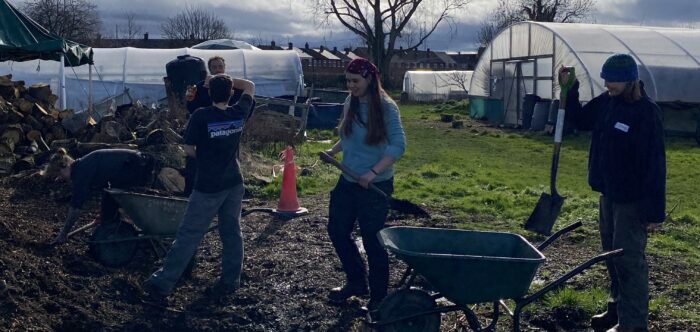 Young people gathering wood chip for mulching at The Bridge Community Farm, Cheshire, during Hedgentines Day 2026.
