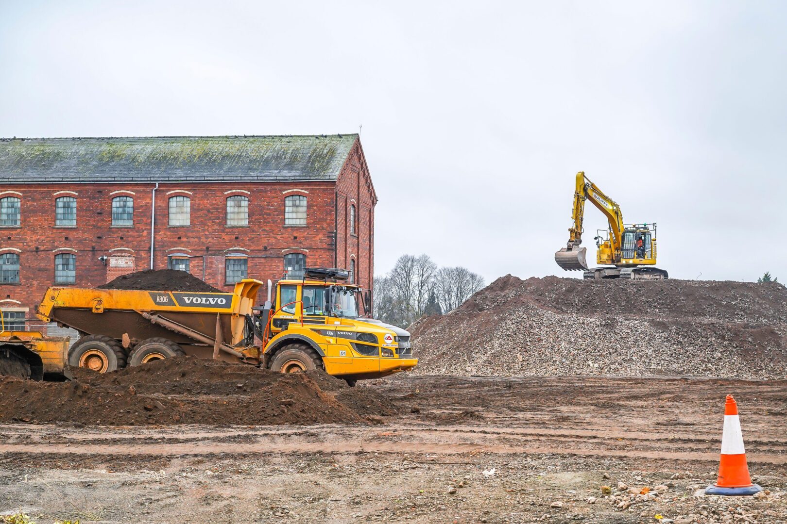 Heavy construction equipment being used in a rejuvenation project on a UK brownfield site.
