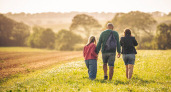 Family walking in a field