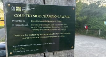 CPRE Norfolk's Countryside Champion Award plaque at the entrance to Quaker Wood, Diss
