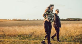 Two women walking in the countryside on a summer evening